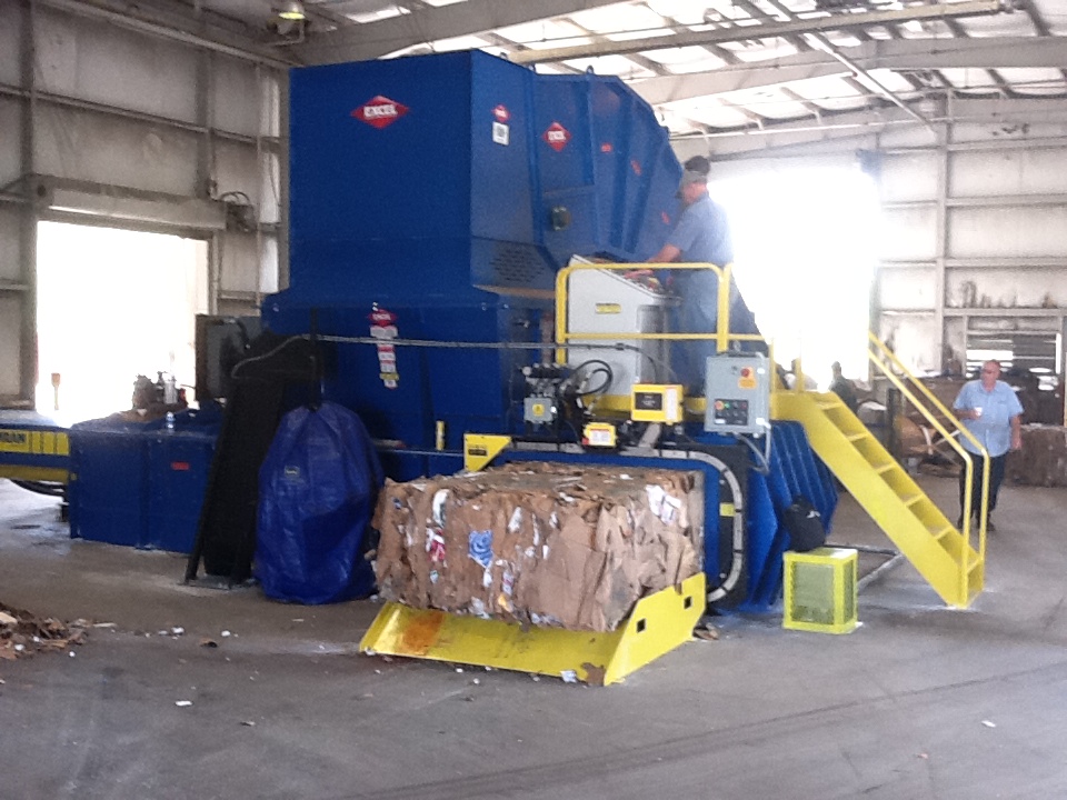 Two-Ram, Auto Tie Baler in an industrial setting 